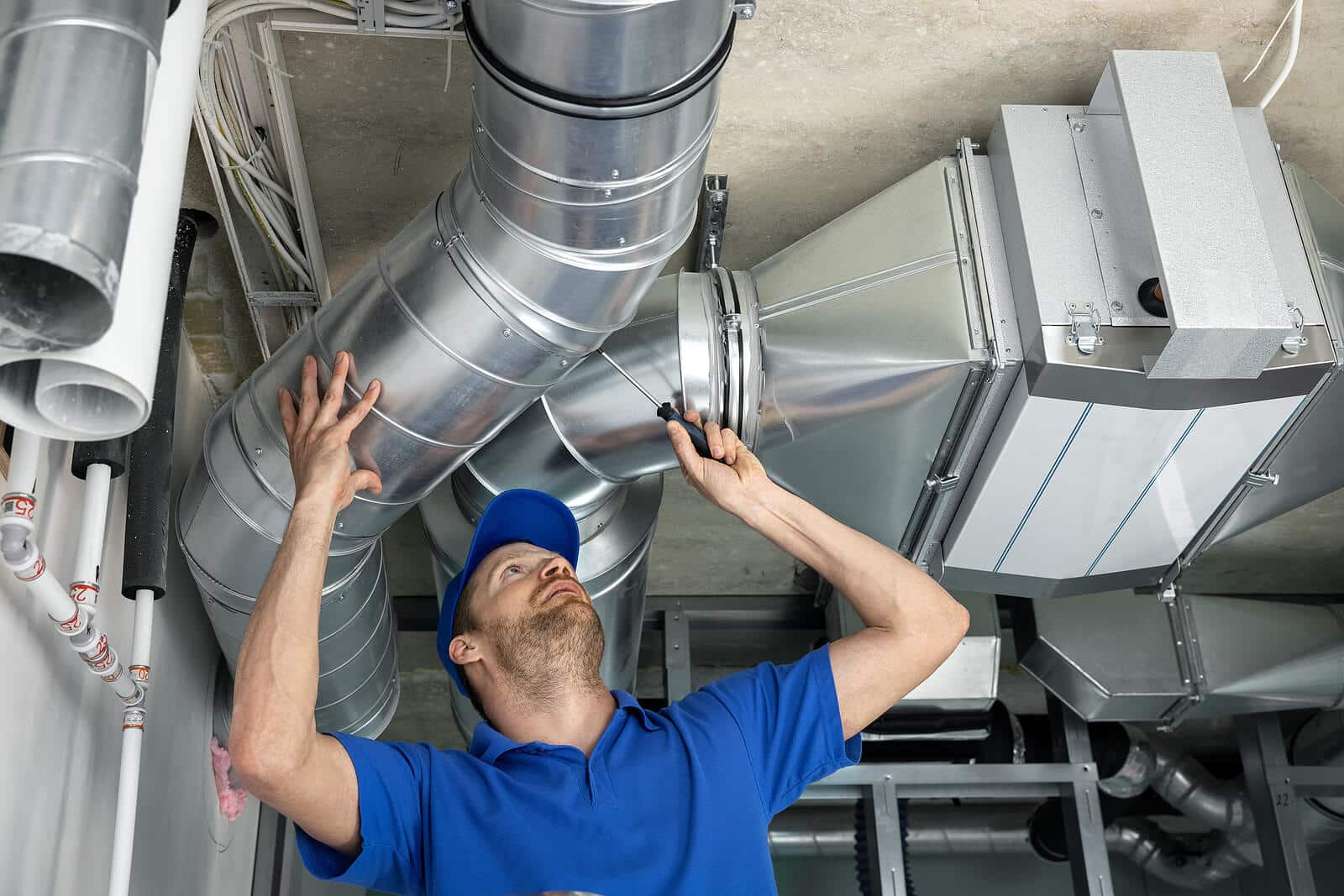 HVAC technician inspecting and repairing air ducts in Daly City