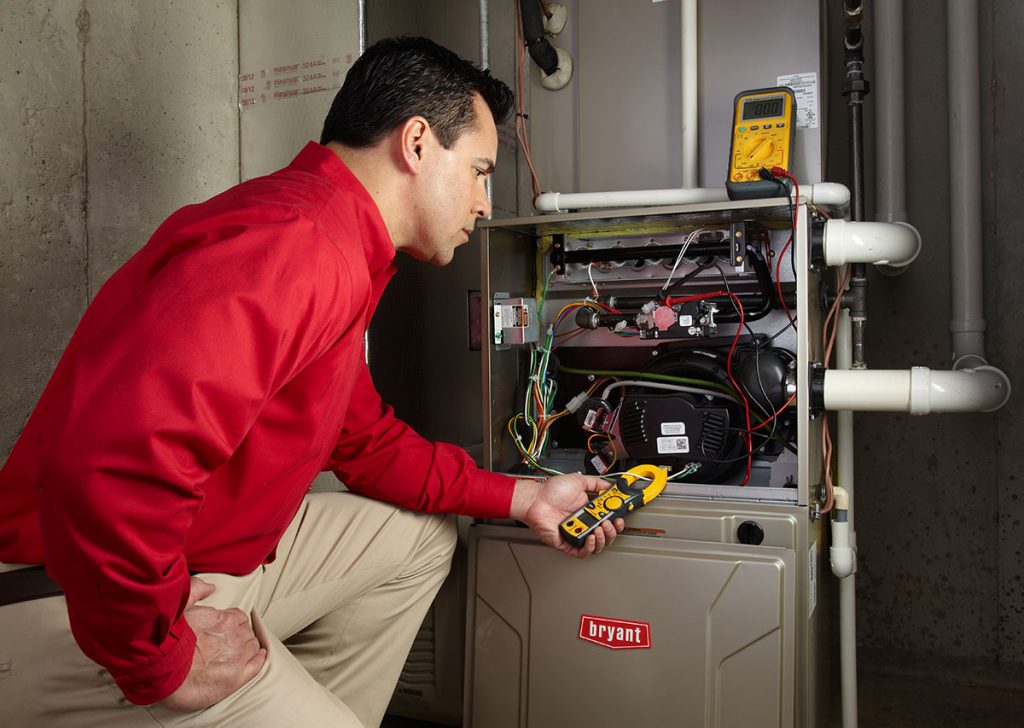 Heating technician diagnosing a furnace repair in Daly City