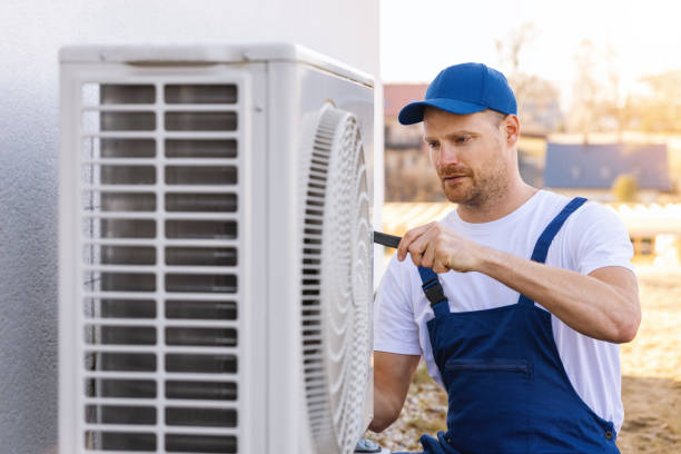 HVAC technician servicing an outdoor air conditioner in Daly City