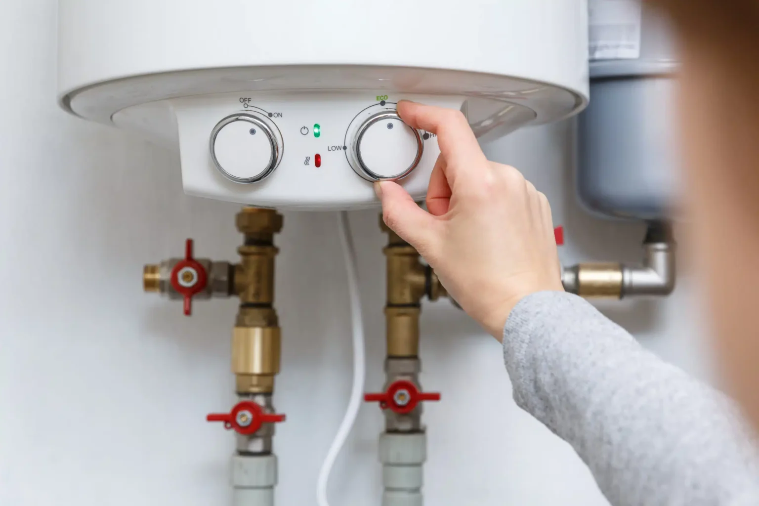 Technician adjusting a water heater in Daly City