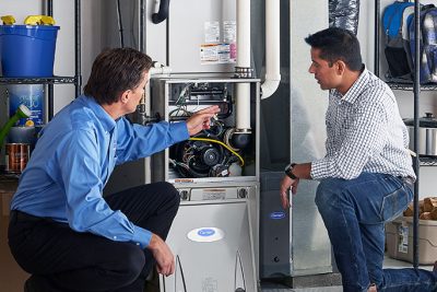 Technician evaluating a furnace for repair or replacement in Daly City