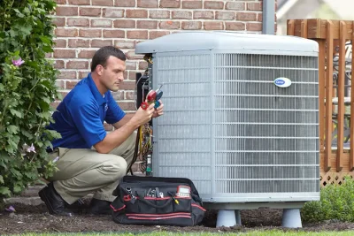 HVAC technician inspecting an outdoor AC unit in Daly City